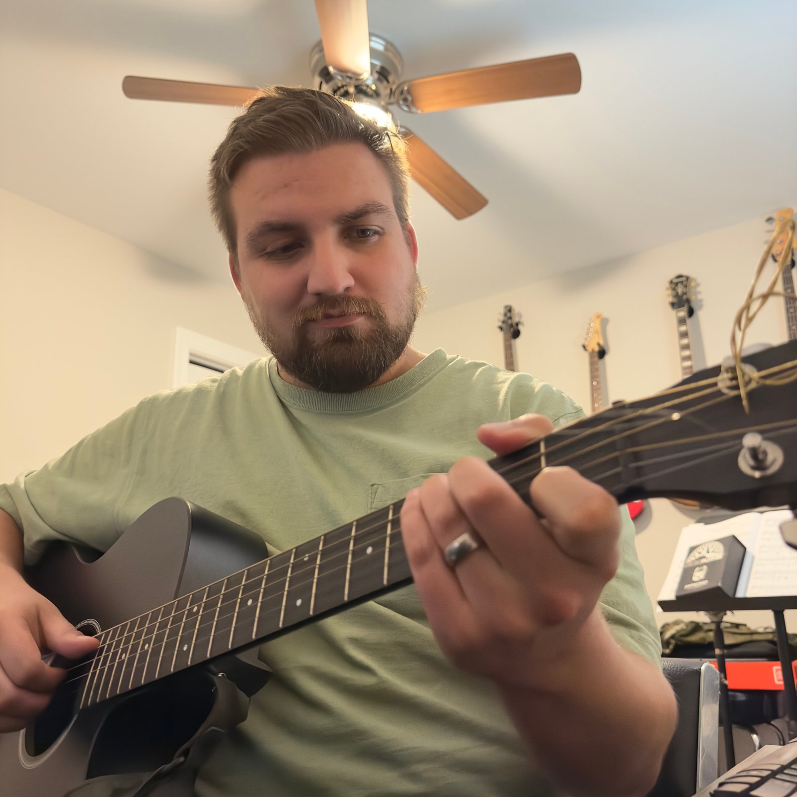 Micah Playing Guitar in studio room